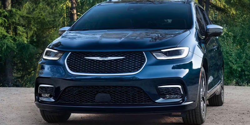 A dark blue Chrysler Pacifica is shown from the front