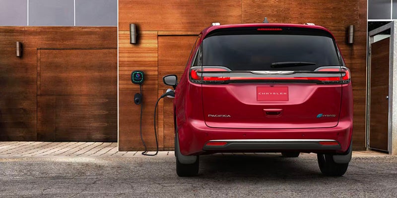 A red Chrysler Pacifica is viewed from the rear