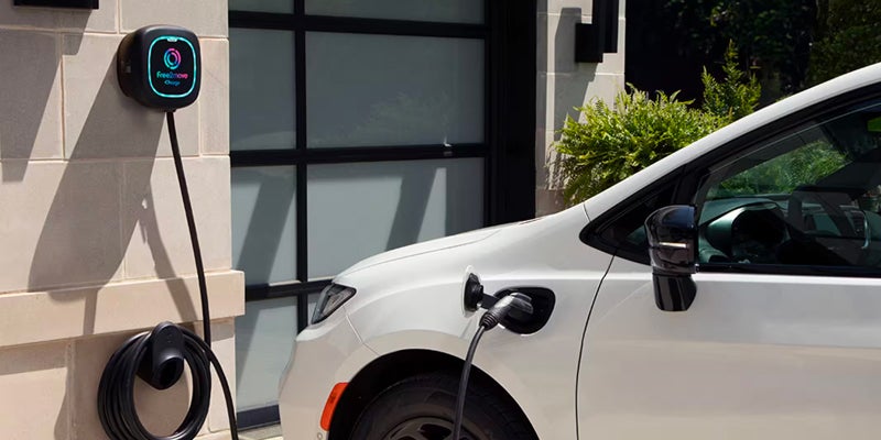 A white Chrysler Pacifica is shown from a front-side angle
